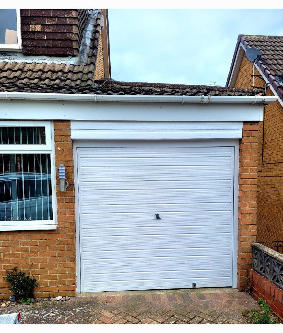 After: up-and-over garage door on a brick bungalow