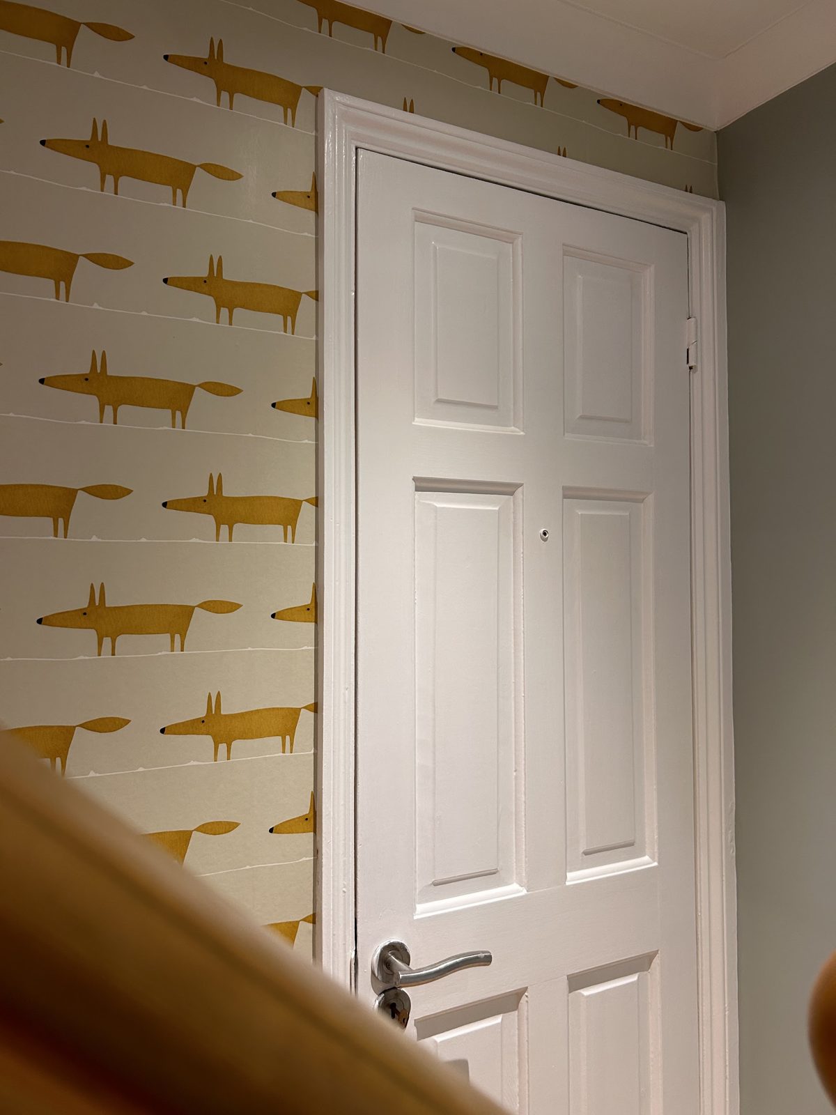 Landing with fox wallpaper and a freshly painted white door